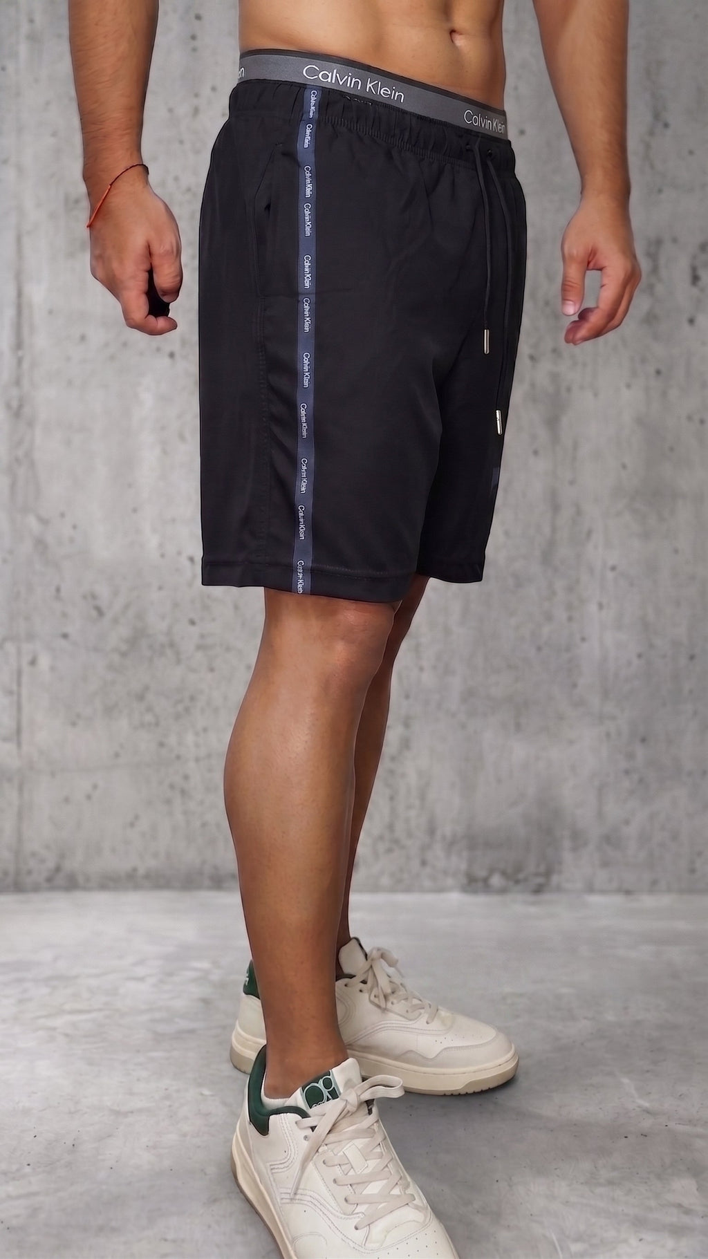 Bermuda deportiva negra para hombre con banda lateral oscura vista diagonal derecha